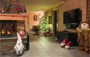 a living room with a christmas tree and a fireplace at 4 Bedroom Lovely Home In Dalen in Dalen