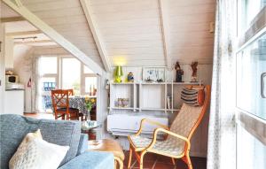 a living room with a couch and chairs at 2 Bedroom Awesome Home In Hvide Sande in Havrvig