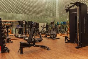 a gym with a bunch of exercise equipment in it at Wine & Books Lisboa Hotel in Lisbon