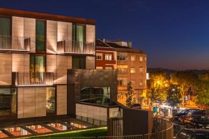 a building on a city street at night at Wine & Books Lisboa Hotel in Lisbon