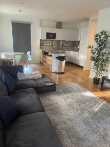 a living room with a couch and a table at Luxurious NEW 2 Bed apartment in London