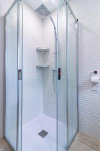 a shower with a glass door in a bathroom at Résidence pieds des pistes in Ax-les-Thermes