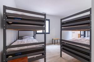 two sets of bunk beds in a room at Résidence pieds des pistes in Ax-les-Thermes
