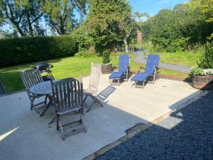 a group of chairs and a table and a grill at New purpose built holiday lodge in Scorton