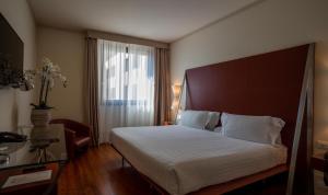 Postel nebo postele na pokoji v ubytování Hilton Garden Inn Florence Novoli