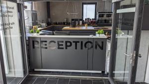 a sign that says reception in a kitchen at Truck-Parking A8 in Heimsheim
