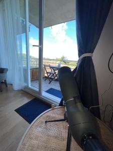 a vacuum in a room with a view of a balcony at Les pieds dans le sable in Malo-les-Bains