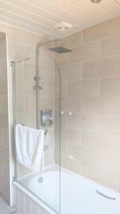 a shower with a glass door in a bathroom at Modern holiday let in Skipton, North Yorkshire in Skipton