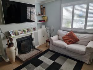 a living room with a white couch and a fireplace at 31 Elwyn Road in March