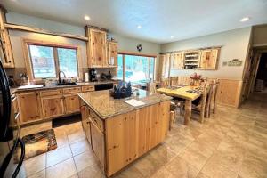 cocina grande con armarios de madera y mesa con comedor en Scenic Solitude, en South Fork