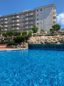 a large swimming pool in front of a building at Apartamento MARINA PLAYA, primera linea de mar in Blanes