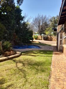 a walkway leading to a yard with a house at Chappel Hide Out in Germiston