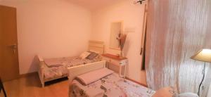 a small room with two beds and a mirror at Apartment in the center of Tavira with swimming pool and garage in Tavira +39 photos