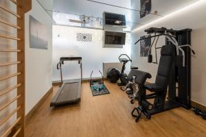 a gym with exercise equipment in a room at Mariposa Hotel Malaga in Málaga