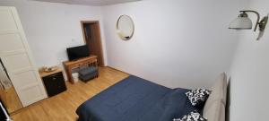 a bedroom with a blue bed and a mirror at Casa Merci in Câmpulung