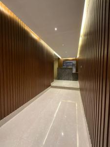a hallway of a building with a wooden wall at ميلاس للوحدات المفروشة in Tabuk