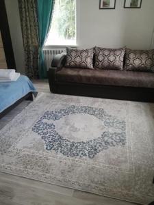 a living room with a couch and a rug at Happy House in Karagandy