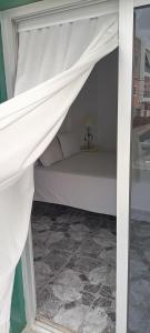 a bed with a white canopy in a room at Gota de Mar in Los Abrigos