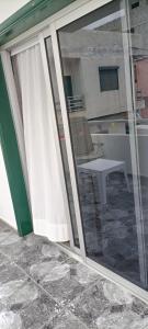 a sliding glass door of a patio with a table at Gota de Mar in Los Abrigos