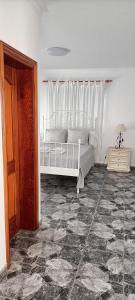 a bedroom with a white bed and a window at Gota de Mar in Los Abrigos