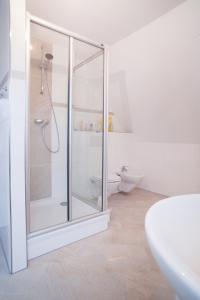 a white bathroom with a shower and a toilet at Ferienhaus Hillesheim in Hillesheim