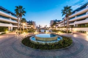 a courtyard with a fountain in front of a building at Flamenca Village Resort apt 83 in Orihuela