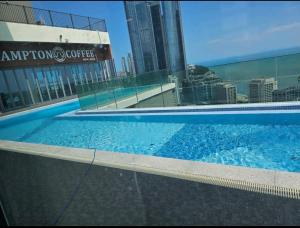 a large swimming pool with a view of a city at Flat nearby Heaundae beach in Busan