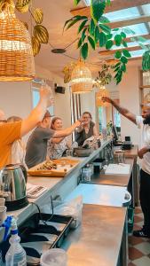 a group of people in a kitchen preparing food at Cordova Hostel Medellin in Medellín