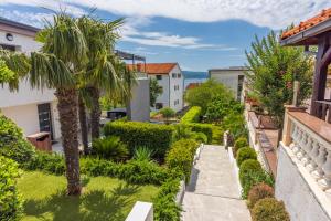 a view of a garden from the balcony of a house at Relax Derossi 2 in Crikvenica