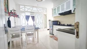 a kitchen with a table and chairs and a sink at Queen Central Apartment Hotel in Ho Chi Minh City