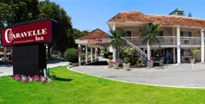 a sign for a carville inn in front of a building at Caravelle Inn Extended Stay in San Jose