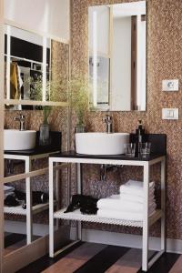 a bathroom with two sinks and two mirrors at room Select Sol in Madrid