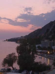 a view of a body of water at sunset at Unique & cozy seaview apartment. in Loutraki