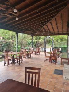 a group of tables and chairs on a patio at Hotel Restaurante Ribera del Chicu in Arriondas
