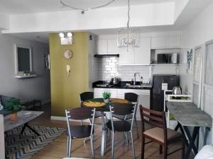 a kitchen with a table and chairs in a room at Abreeza place T1-1702 in Davao City