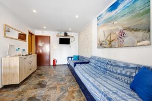 a living room with a couch and a painting on the wall at Azul do Mar in Portimão