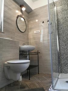 a bathroom with a toilet and a sink and a shower at Apartment Kiki Candy in Malinska +29 photos