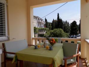 a table with a green table cloth and oranges on it at Apartment Kiki Candy in Malinska