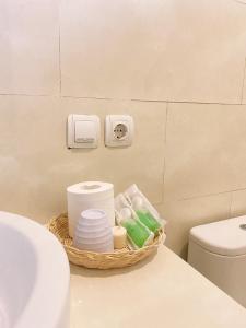 a bathroom with a basket of toiletries on a counter at La Cascata Bali Munduk in Munduk