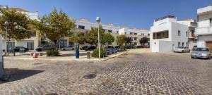 a cobblestone street in a city with buildings at Apartment in the center of Tavira with swimming pool and garage in Tavira