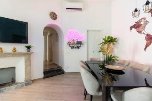 a living room with a table and a fireplace at Maison Piazza di Spagna in Rome