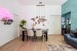 a dining room with a table and a blue couch at Maison Piazza di Spagna in Rome