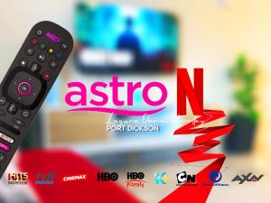 a remote control sitting next to a sign that reads asico n at Laguna Damai Homestay Teluk Kemang PortDickson 3BR in Port Dickson