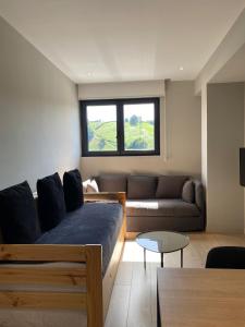 a living room with a bed and a couch at Milimara Suites in San Sebastián