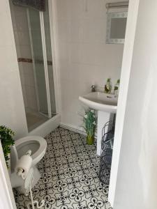 a bathroom with a toilet and a sink at The Hideaway!! Skegness ground floor room free parking in Skegness