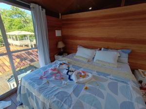 a bedroom with a bed with two babies on it at SUITE BANGALÔ ILHA Da FANTASIA in Belém +18 photos