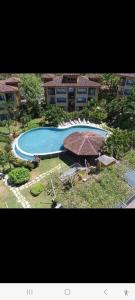 an overhead view of a swimming pool in front of a building at Beautiful newly refurbished 2 bedroom 2 Bathroom 2nd floor condo in Tamarindo