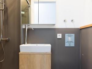 a bathroom with a white sink and a mirror at Guimerá Family Suites A in Santa Cruz de Tenerife