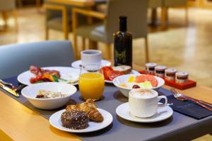 a table topped with plates of breakfast foods and drinks at Hotel SB Diagonal Zero 4 Sup in Barcelona