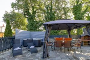 a patio with a table and chairs under an umbrella at Casa Martina with Whirlpool in Barban